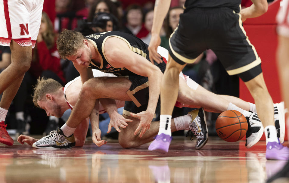 Nebraska's Rienk Mast, left, dives for a loose ball against Purdue's Caleb Furst during the second half of an NCAA college basketball game Tuesday, Jan. 9, 2024, in Lincoln, Neb. Nebraska won 88-72. (AP Photo/Rebecca S. Gratz)