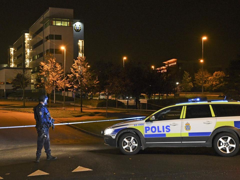 A police officer stands guard outside the roped off area surrounding the police station in Helsingbor (EPA)
