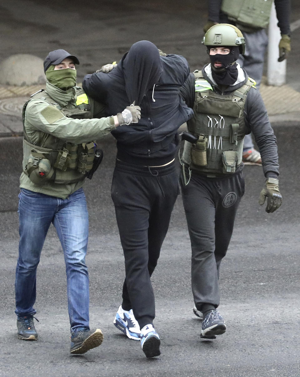 Police detain a man during an opposition rally to protest the official presidential election results in Minsk, Belarus, Sunday, Nov. 8, 2020. Club-swinging police went after demonstrators in the Belarusian capital who were demanding the resignation of the country's authoritarian president on Sunday, the 90th consecutive day of protests in the country. Human rights activists said nearly 400 people were arrested. (AP Photo)