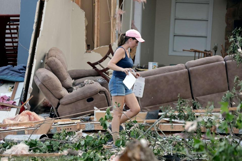 PHOTO: A woman surveys the damage to her home that was destroyed by a tornado on July 19, 2023, in Dortches, N.C. (Chris Seward/AP)