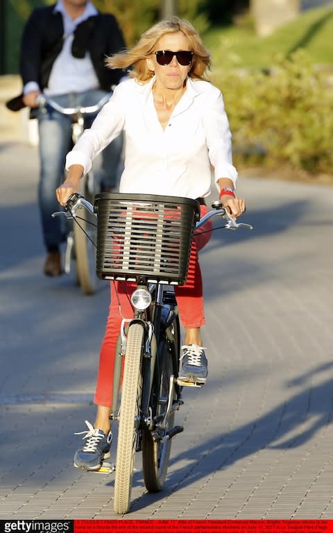 Wife of French President Emmanuel Macron, Brigitte Trogneux returns to her home on a bicycle in Le Touquet  - Credit:  Getty Images Europe