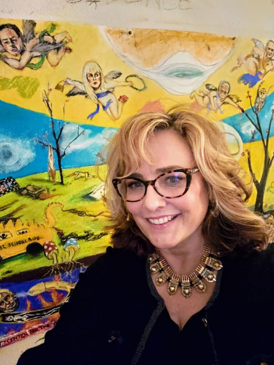 <div class="inline-image__caption"><p>Maria Farmer poses in front of her artwork of “the elites” who turned a blind eye to Epstein’s abuse.</p></div> <div class="inline-image__credit">Courtesy of Maria Farmer</div>