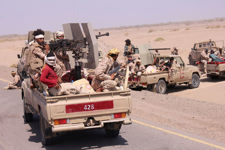 Members of the Yemeni army ride on the back of military trucks near the Red Sea coast city of al-Mokha, Yemen January 23, 2017. REUTERS/Fawaz Salman