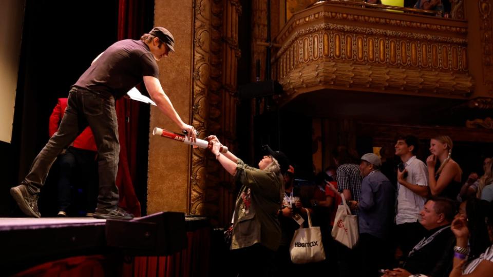 AUSTIN, TEXAS - MARCH 12: Robert Rodriguez gives posters to fans during the Q+A for Hypnotic (Work-in-Progress) screening during the 2023 SXSW Conference and Festivals at The Paramount Theater on March 12, 2023 in Austin, Texas.  (Photo by Frazer Harrison/Getty Images for SXSW)