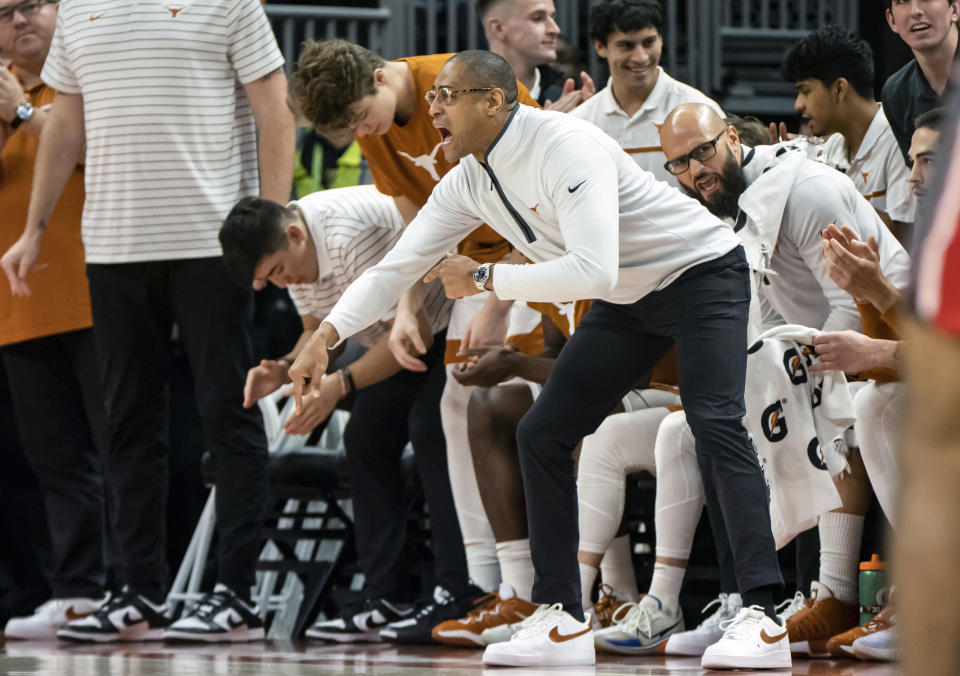 Texas acting head coach Rodney Terry, center, directs his team during the first half of an NCAA college basketball game against Louisiana-Lafayette, Wednesday, Dec. 21, 2022, in Austin, Texas. (AP Photo/Michael Thomas)