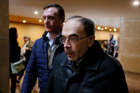 FILE PHOTO: Cardinal Philippe Barbarin, Archbishop of Lyon, walks inside the courthouse during a break on the last day of his trial, charged with failing to act on historical allegations of sexual abuse of boy scouts by a priest in his diocese, at the courthouse in Lyon, France, January 10, 2019. REUTERS/Emmanuel Foudrot/File Photo