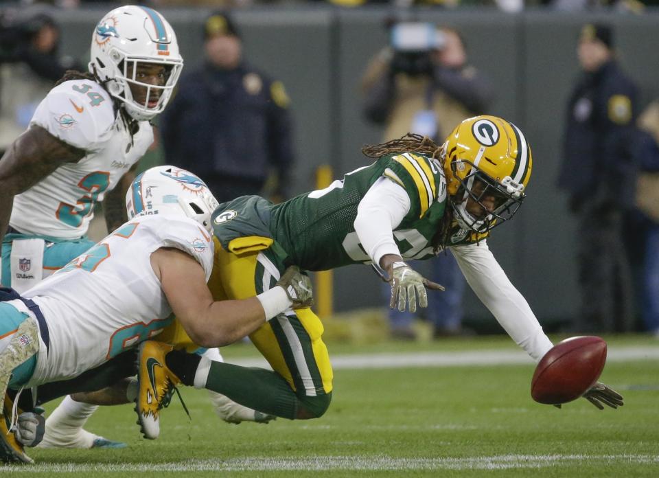 Green Bay Packers' Tramon Williams loses the ball as he runs back a punt during the first half of an NFL football game against the Miami Dolphins Sunday, Nov. 11, 2018, in Green Bay, Wis. (AP Photo/Mike Roemer)