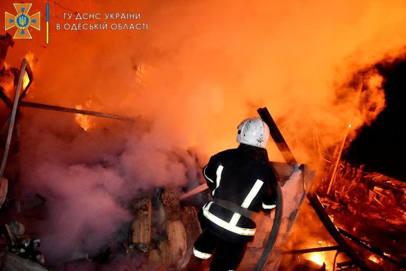 Firefighters work at a scene after a shelling in a location given as Odesa