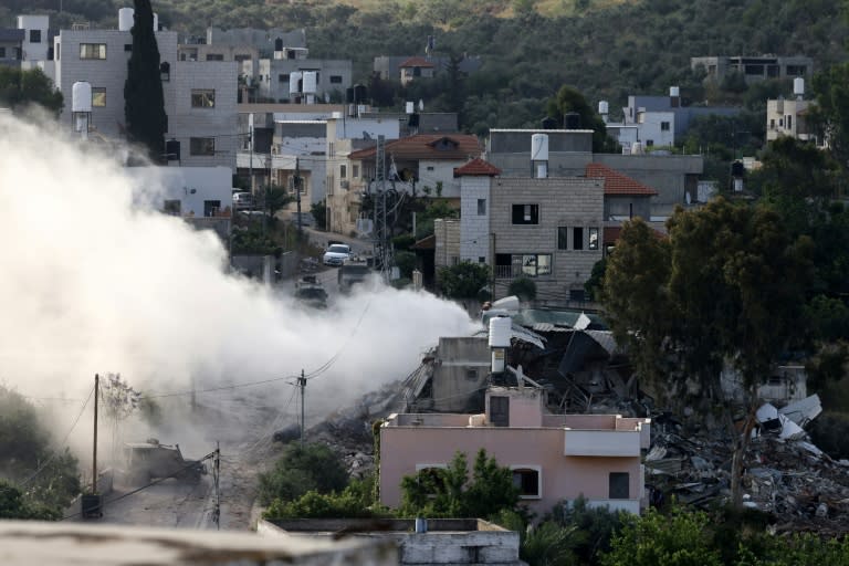 Smoke pours out of a besieged bilding during an Israeli raid on the village of Deir al-Ghusun in the occupied West Bank (JAAFAR ASHTIYEH)