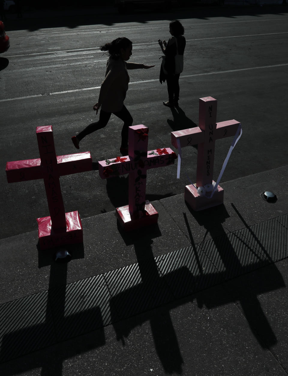 Women place crosses in Mexico City's main square the Zocalo, during the International Women's Day strike "A day without women," Monday, March 9, 2020. Thousands of women across Mexico went on strike after an unprecedented number of girls and women took to the streets to protest against unbridled gender violence on International Women's Day. (AP Photo / Marco Ugarte)