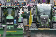 Farmers with their tractors begin to arrive near the European Quarter, during a demonstration outside of a meeting of EU agriculture ministers at the European Council building in Brussels, Tuesday, March 26, 2024. Tuesday marks the third time this year that farmers will take to the streets of Brussels with their tractors. (AP Photo/Virginia Mayo)