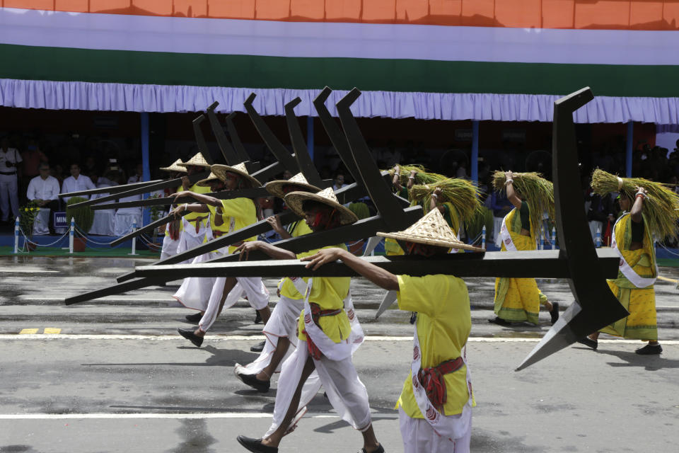 Farmers carrying ploughs walk during Independence Day ceremonial parade in Kolkata, India, Wednesday, Aug. 15, 2018. India won independence from British colonialists in 1947. (AP Photo/Bikas Das)