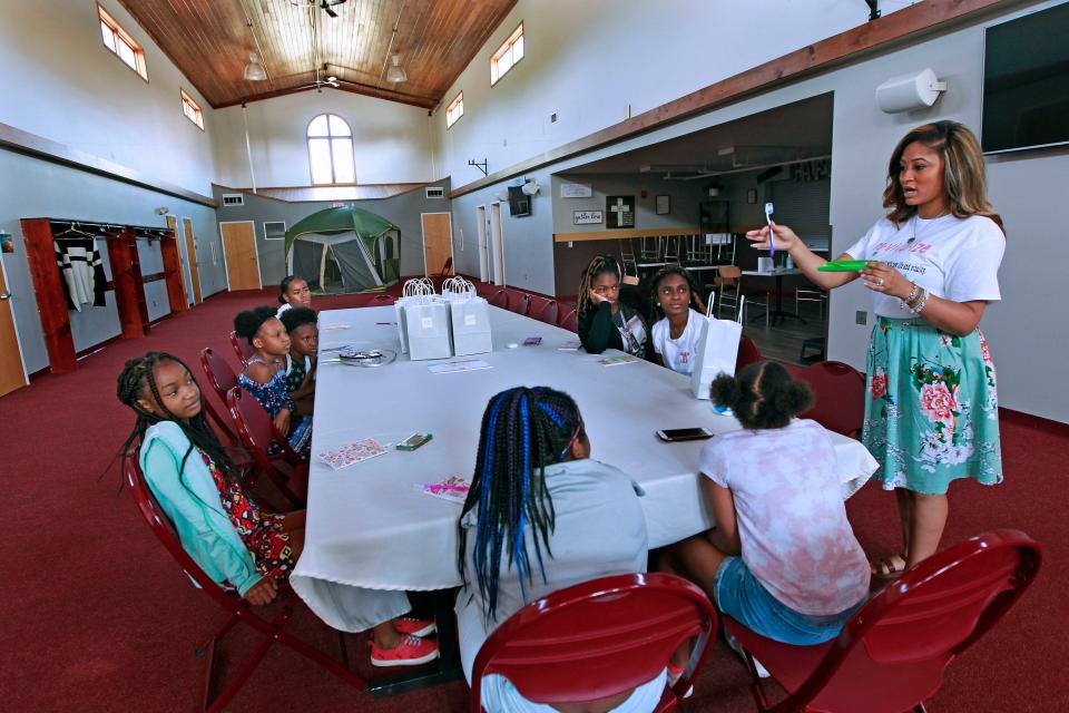 Rahshenia Patrick talks to girls about the benefits of proper dental habits while holding a health and wellness workshop for girls ages 10 to 15.