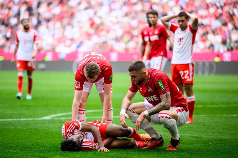 Munich's Kingsley Coman lies injured on the ground during the German Bundesliga soccer match between Bayern Munich and 1. FC Cologne at Allianz Arena. Tom Weller/dpa