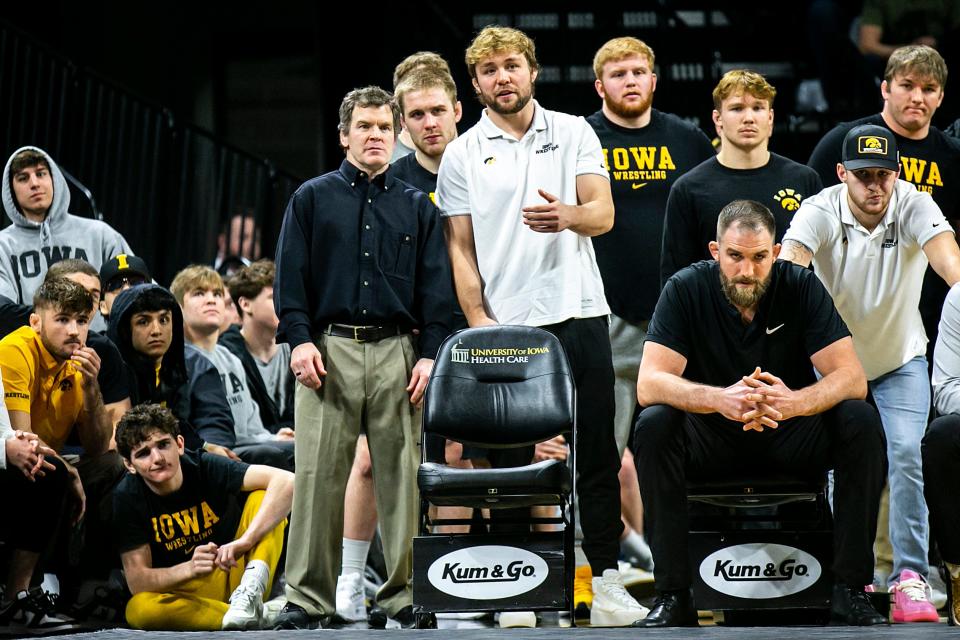 Iowa associate head coach Terry Brands talks with 197-pound wrestler Jacob Warner as they watch a match during a NCAA Big Ten Conference men's wrestling dual against Northwestern, Friday, Jan. 13, 2023, at Carver-Hawkeye Arena in Iowa City, Iowa.