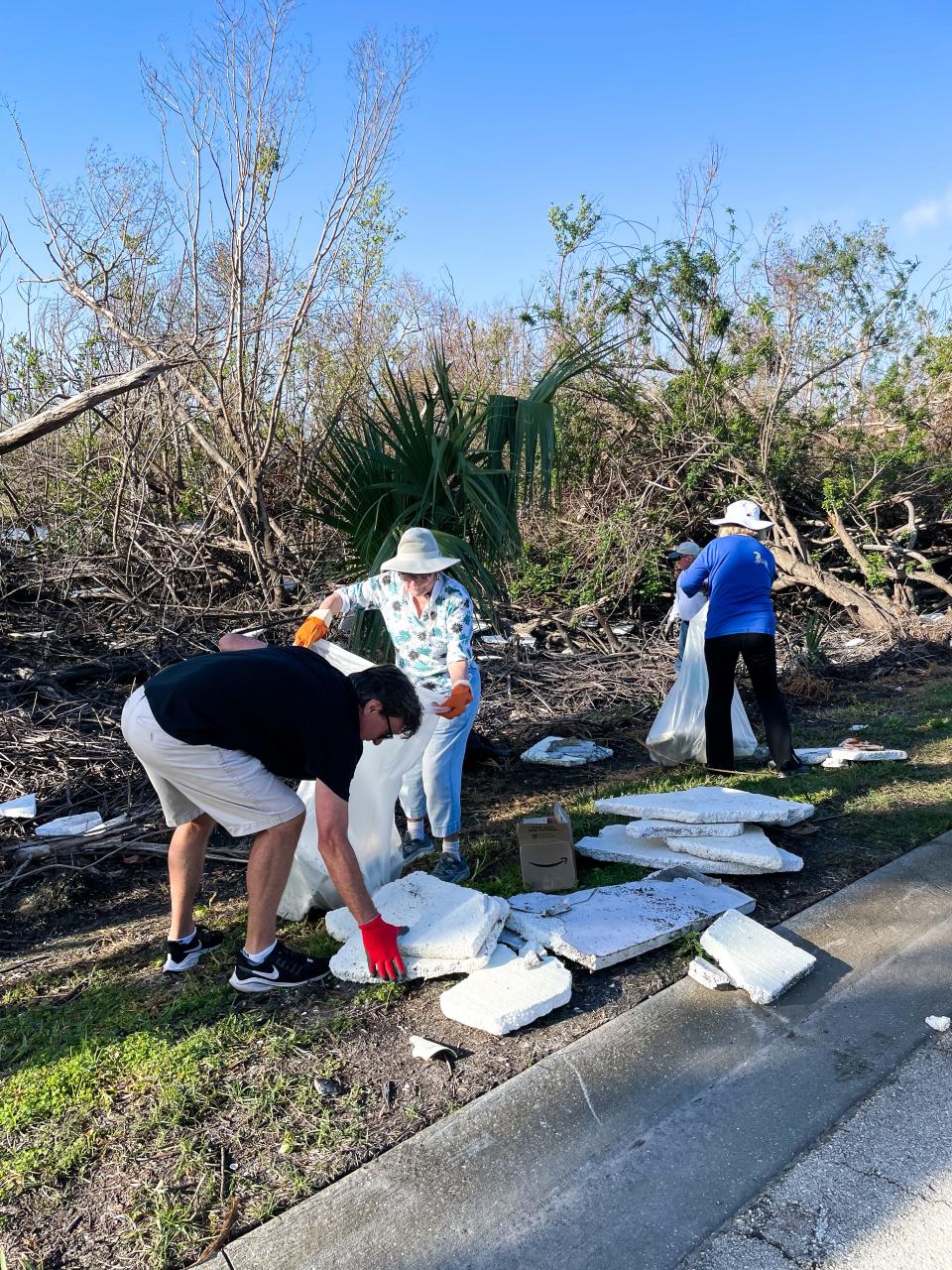 Residents of the Kelly Green community in Fort Myers working on cleaning up after Hurricane Ian last September.