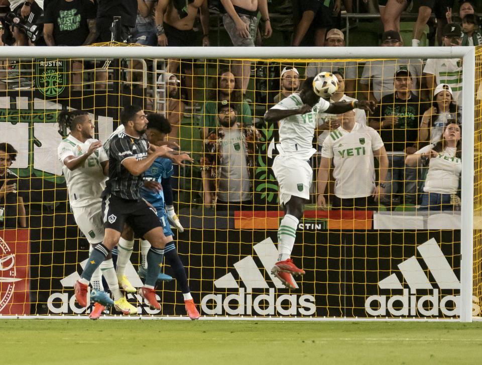 Austin forward Moussa Djitté heads the ball away from the goal during the first half of an MLS soccer match against the LA Galaxy, Sunday, Sept. 26, 2021, in Austin, Texas. (AP Photo/Michael Thomas)