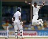 India's Stuart Binny (R) celebrates after taking the wicket of Sri Lanka's Dinesh Chandimal (L) during the third day of their third and final test cricket match in Colombo , August 30, 2015. REUTERS/Dinuka Liyanawatte