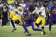 Minnesota Vikings running back Dalvin Cook (33) runs from Pittsburgh Steelers safety Terrell Edmunds (34) and inside linebacker Joe Schobert (93) during the first half of an NFL football game, Thursday, Dec. 9, 2021, in Minneapolis. (AP Photo/Bruce Kluckhohn)