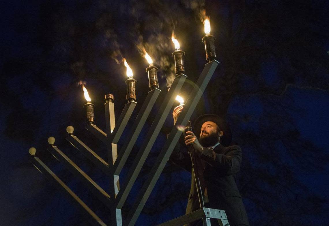 Rabbi Yisroel Cotlar of Chabad of Cary lights a 10-foot menorah to celebrate the fifth night of Hanukkah or 28 Kislev 5776, Thursday, December 10, 2015 during the annual Jewish Cultural Festival hosted at the Cary Arts Center. The event featured traditional Jewish music, a kosher food sale, children’s crafts and a nonperishable food drive to benefit the Jewish Family Services Food Bank. “We’ve reached the tipping point where there is more light than darkness,” said Cotlar before lighting the menorah.