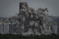 Cloud of dust rises as twin high-rise apartment towers are razed to ground in Noida, outskirts of New Delhi, India, Sunday, Aug. 28, 2022. The demolition was done after the country's top court declared them illegal for violating building norms. The 32-story and 29-story towers, constructed by a private builder were yet to be occupied and became India's tallest structures to be razed to the ground. (AP Photo/Altaf Qadri)