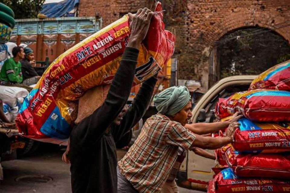 Labours push a cart loaded with sealed sacks of spices in Kolkata (AFP/Getty)