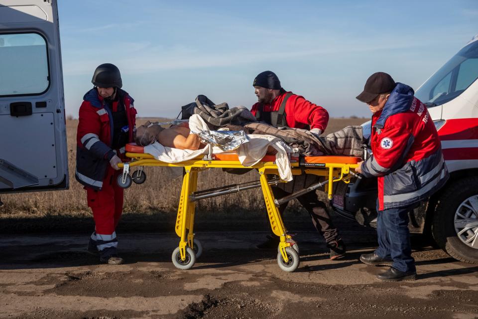 Medics evacuate to Kherson a local resident after he was wounded during a Russian military strike in Berislav yesterday (Reuters)