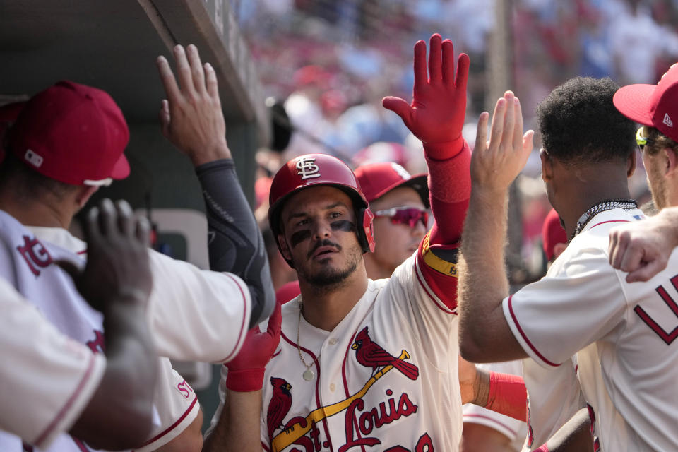 St. Louis Cardinals' Nolan Arenado is congratulated by teammates after hitting a solo home run during the ninth inning of a baseball game against the Cincinnati Reds Saturday, June 10, 2023, in St. Louis. (AP Photo/Jeff Roberson)