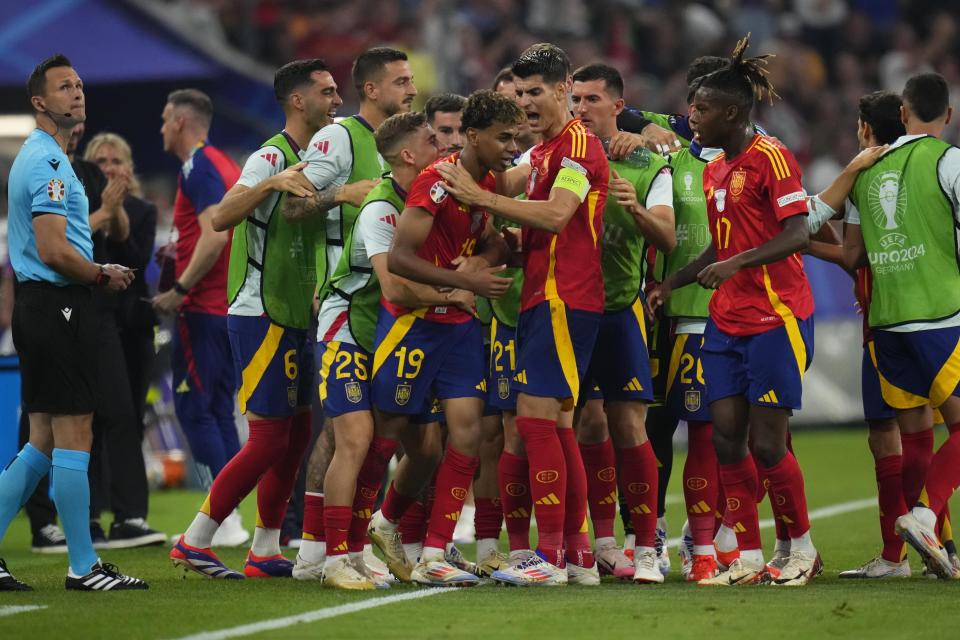 Spain's Lamine Yamal celebrates with his teammate after scoring his side's first goal during a semifinal match between Spain and France at the Euro 2024 soccer tournament in Munich, Germany, Tuesday, July 9, 2024. (AP Photo/Manu Fernandez)