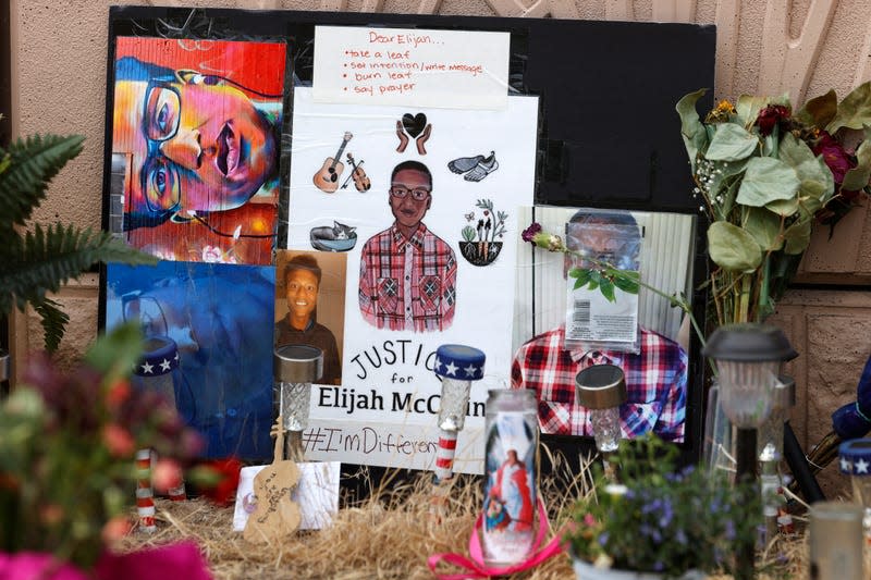 A makeshift memorial stands at a site across the street from where Elijah McClain was stopped by Aurora, Colo., Police Department officers while walking home. 