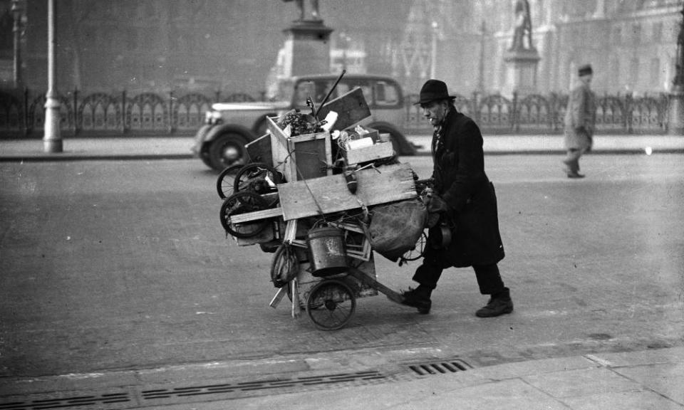 10th December 1936: A tramp pushing his belongings in a cart through Parliament Square, Westminster.