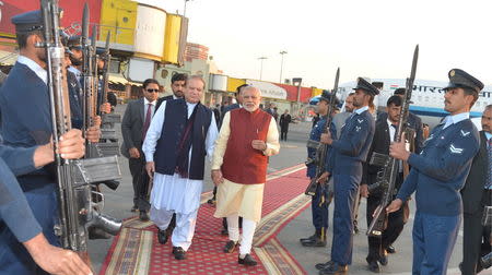 Pakistani Prime Minister Nawaz Sharif (L) walks with his Indian counterpart Narendra Modi after Modi's arrival in Lahore, Pakistan, December 25, 2015. REUTERS/Press Information Department (PID)/Handout via Reuters