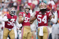 San Francisco 49ers defensive end Nick Bosa (97) celebrates after sacking Miami Dolphins quarterback Tua Tagovailoa with teammates Samson Ebukam (56) and Fred Warner (54) during the first half of an NFL football game in Santa Clara, Calif., Sunday, Dec. 4, 2022. (AP Photo/Godofredo A. Vásquez)