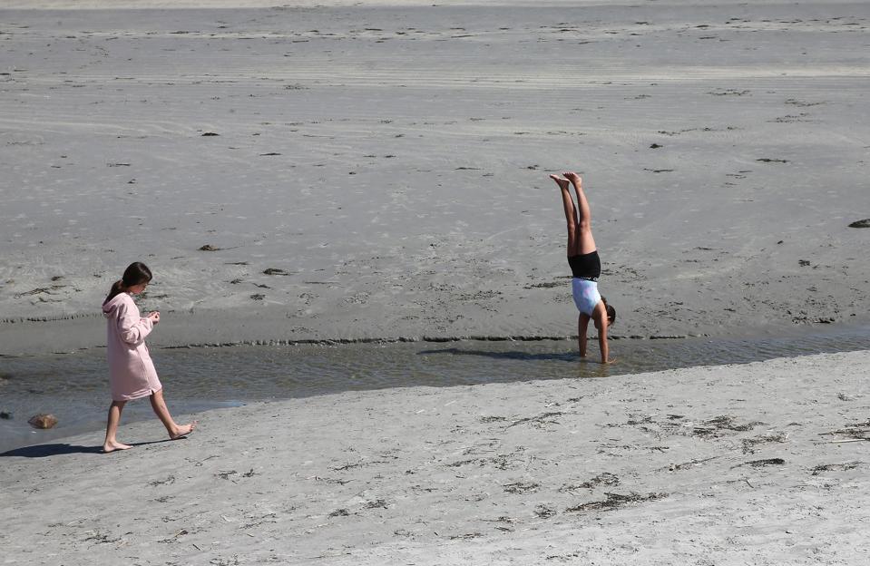 Kids have fun in the water and sand at Long Sands Beach in York on a beautiful Friday afternoon.