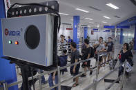 Passengers from a ferry from Singapore pass by an infrared scanner before passport control at the international ferry terminal in Batam, Riau Islands, Indonesia August 31, 2016, in this photo taken by Antara Foto. Antara Foto/M N Kanwa/via REUTERS