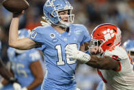 Clemson defensive end K.J. Henry (5) pressures North Carolina quarterback Drake Maye (10) in the first half during the Atlantic Coast Conference championship NCAA college football game on Saturday, Dec. 3, 2022, in Charlotte, N.C. (AP Photo/Jacob Kupferman)