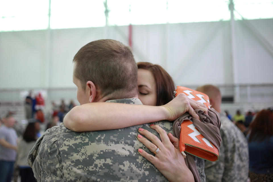 Warrant Officer&nbsp;Anthony Woodmansee of the U.S. Army's 101st Airborne Division is embraced by his wife Emily Woodmansee during a homecoming ceremony at Campbell Army Airfield on March 21, 2015, in Fort Campbell, Kentucky.