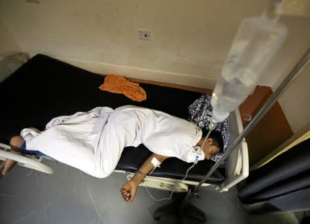 A rescued migrant lies in bed as he receives treatment at Rashid hospital in the port city of Rosetta, north of Cairo, Egypt, September 22, 2016. REUTERS/Mohamed Abd El Ghany