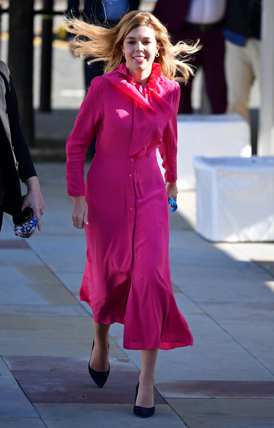 On the 4th day of the Conservative Party Conference, Carrie Symonds wore yet. another affordable midi dress. She donned a bright pink £85 & Other Stories dress which she styled with a pair of black pointed shoes. <a href="https://fave.co/32ZKAAI" rel="noopener" target="_blank" data-ylk="slk:Shop now;elm:context_link;itc:0;sec:content-canvas" class="link ">Shop now</a>. <em>[Photo: Getty Images]</em>