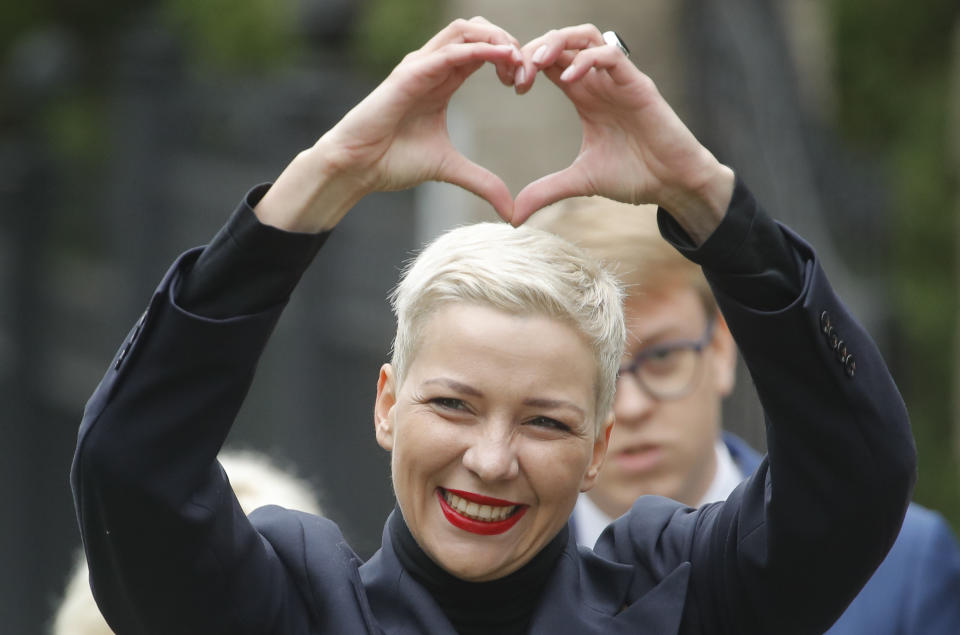 FILE - In this Aug. 27, 2020, file photo, Maria Kolesnikova, one of Belarus' opposition leaders, gestures on the way to the Belarusian Investigative Committee in Minsk, Belarus. Kolesnikova, a professional flute player with no political experience, emerged as a key opposition activist in Belarus. She has appeared at protests of authoritarian President Alexander Lukashenko after he was kept in power by an Aug. 9 election that his critics say was rigged. (AP Photo/Dmitri Lovetsky, File)