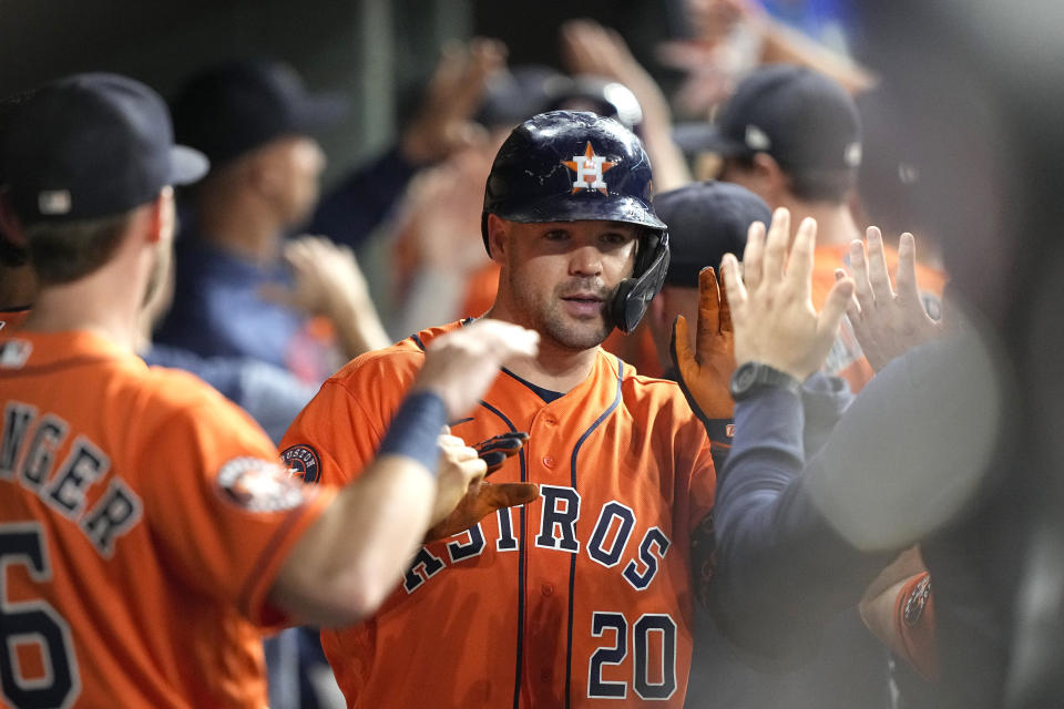 Houston Astros' Chas McCormick (20) celebrates in the dugout after hitting a three-run home run against the Kansas City Royals during the eighth inning of a baseball game Friday, Sept. 22, 2023, in Houston. (AP Photo/David J. Phillip)