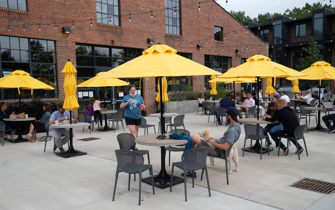 The outdoor dining area at the Transfer Co. Food Hall on E. Davie Street on Friday, October 9, 2020 in Raleigh, N.C. Cement tables are spaced out for social distancing, preventing patrons from moving tables together.