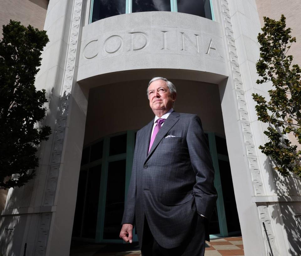 Developer Armando Codina stands at the entrance to the new office and apartment complex he built in downtown Coral Gables.