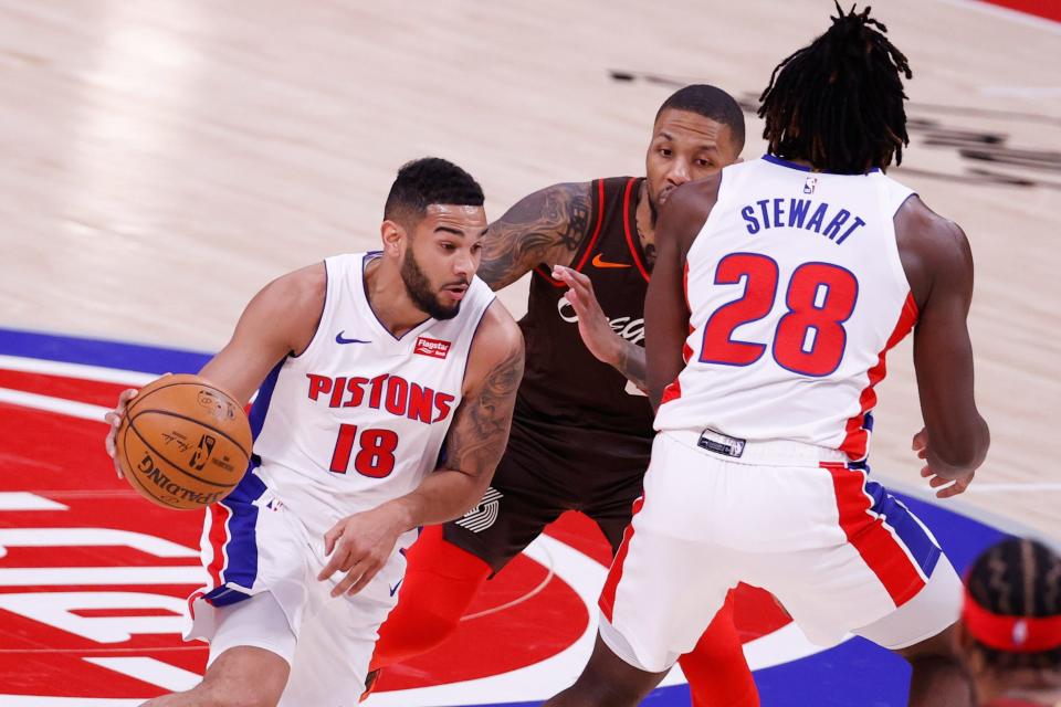 Detroit Pistons guard Cory Joseph (18) dribbles around center Isaiah Stewart (28) defended by Portland Trail Blazers guard Damian Lillard (0) at Little Caesars Arena on March 31, 2021.