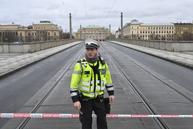 <p>CTK via AP Images</p> A police officer patrols the closed Manes Bridge