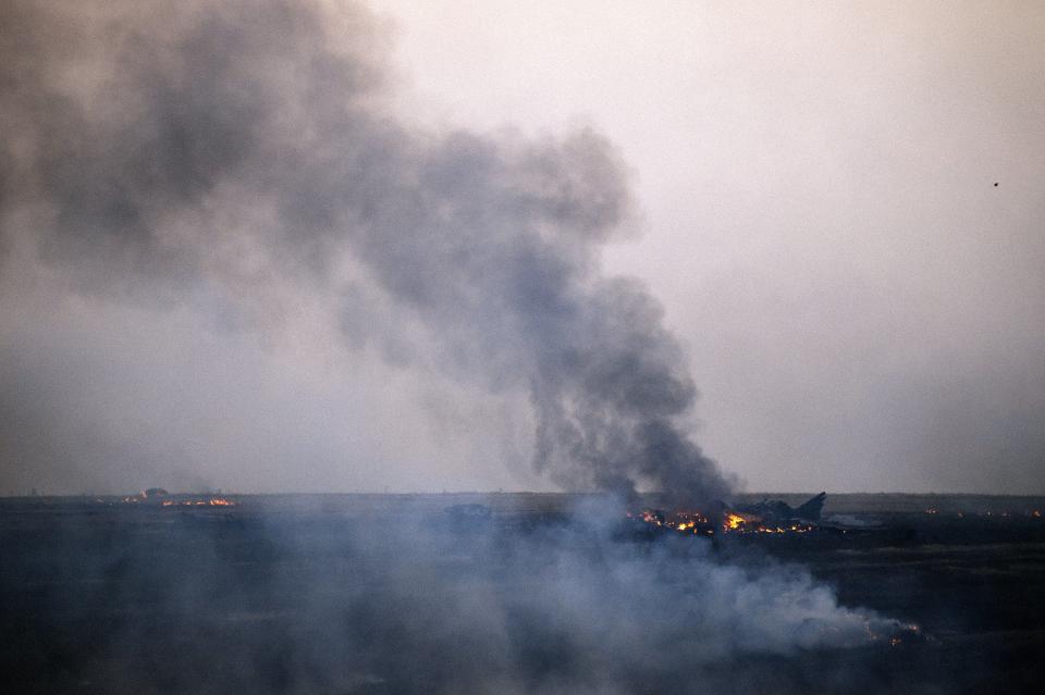 Smoke billows from the flaming debris of a crashed Ukrainian fighter jet near the Donetsk area in eastern Ukraine in 2014. The aircraft was flying low low over rebel-held territory. (Dimitar Dilkoff/AFP via Getty Images)
