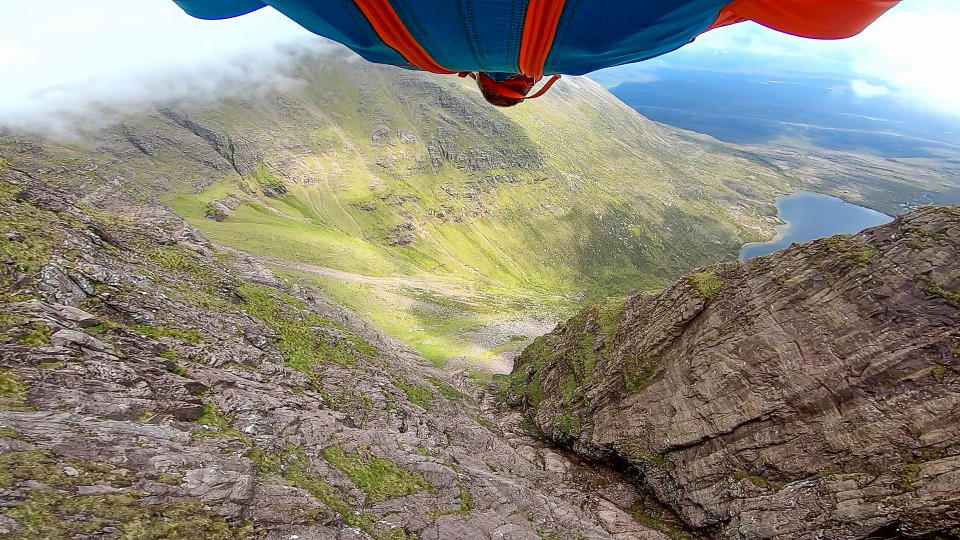 A brave base jumper has become the first person ever to fly a wingsuit from the top of a British mountain. Former Royal Marine Tim Howell, 31, leapt from the 4,000ft peak of An Teallach in the northwest Highlands in Scotland. He plunged down a steep gully for 30 seconds before deploying his parachute and landing safely on the banks of Loch Toll an Lochain.