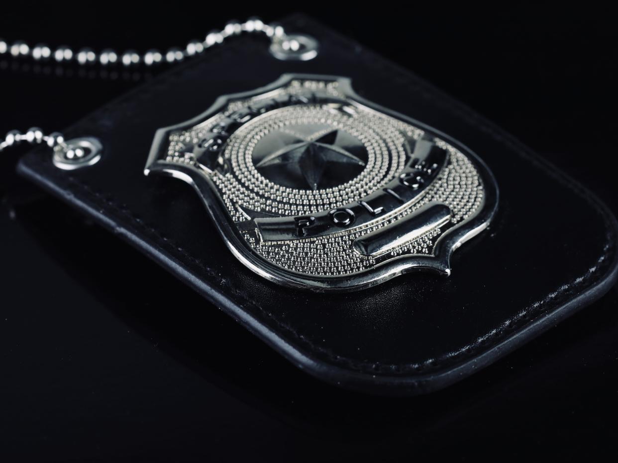 A police badge for detectives against a black background.