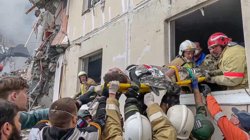 In this photo taken from video released by Belgorod regional governor Vyacheslav Gladkov's Telegram channel on Sunday, May 12, 2024, Russian emergency services transport a wounded person from a partially collapsed block of flats authorities said was hit during an attack by Ukrainian shelling, in Belgorod, Russia. In a statement, Russia's Investigative Committee, the country's top law enforcement agency, said that the 10-story block had been hit by Ukrainian shelling. (Belgorod Region Governor Vyacheslav Gladkov Telegram channel via AP)