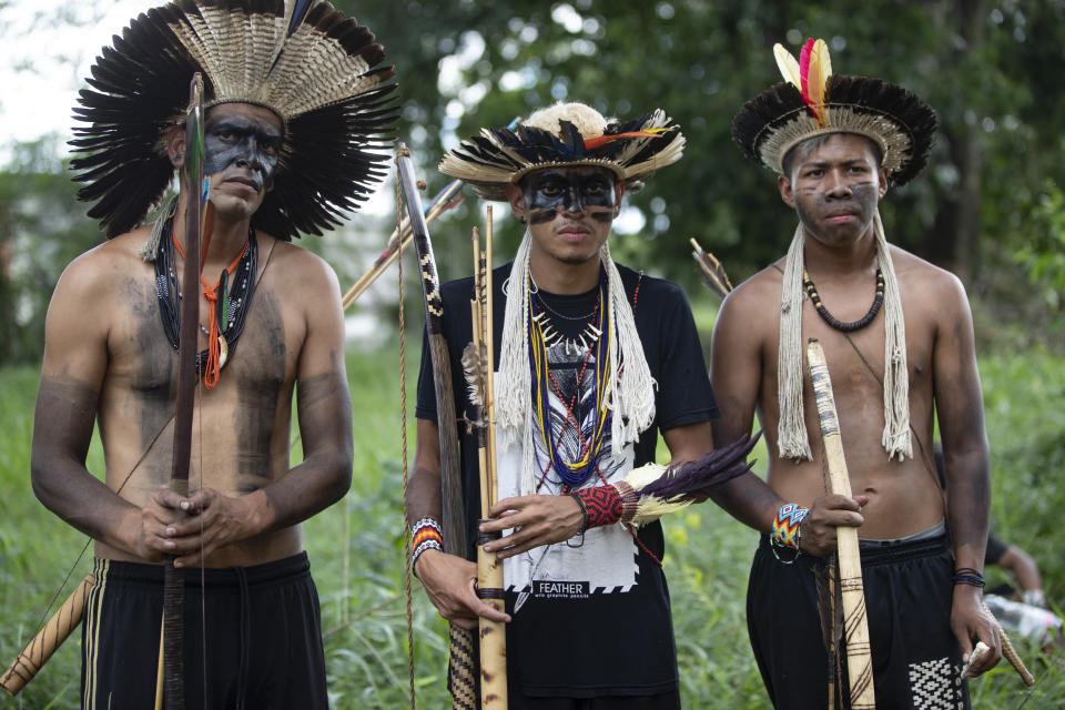 Guarani Mbya protesters in traditional indigenous dress occupy land being cleared for apartment buildings by real estate company Tenda, next to their community's property in Sao Paulo, Brazil, Thursday, Jan. 30, 2020. The tension between a builder with projects in nine Brazilian states and a 40-family indigenous community is a microcosm of what’s playing out elsewhere in the country. (AP Photo/Andre Penner)